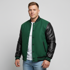 Man wearing a green varsity jacket with black leather sleeves on a gray background