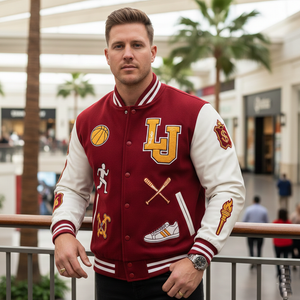 Man wearing a maroon and white varsity jacket with various logos in an indoor setting.