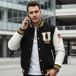 Man wearing a black and white letterman jacket with 'Utah' on it, talking on a phone.