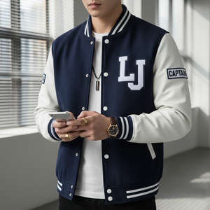 Person wearing a navy and white varsity jacket with 'LJ' initials, holding a phone indoors.