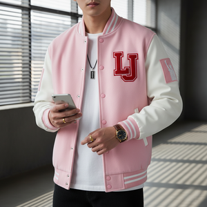 Person wearing a pink varsity jacket with 'LJ' lettering, holding a phone.