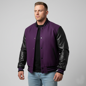 Man wearing a purple varsity jacket with black sleeves on a gray background
