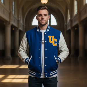 student wearing letterman jacket, UC patch on front, standing in university hall