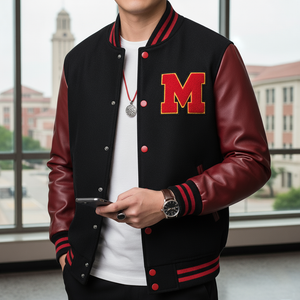 a man wearing a black varsity jacket with dark red/maroon leather sleeves and a large red and gold letter 'M' patch