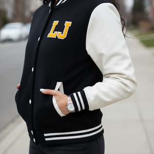 Back view of affordable women's varsity jacket displaying black Melton wool blend body, white genuine wool sleeves, and ribbed waistband
