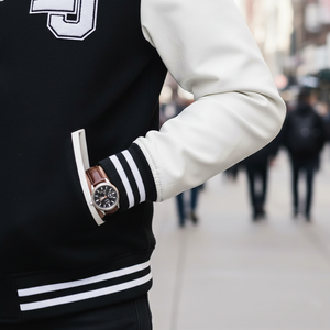 Detailed view of big and tall letterman jacket sleeve with bold distinctions and varsity patch accents