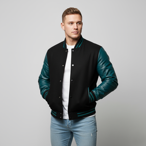Man wearing a black and teal varsity jacket on a gray background