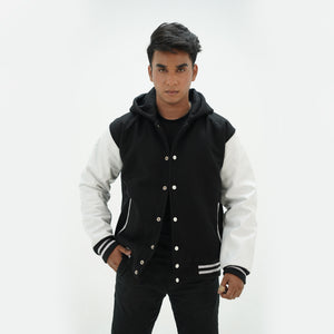 Black and white letterman jacket with hoodie combining traditional varsity style with modern hooded design for campus life