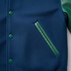 Close-up of a blue jacket with green buttons and a pocket on a white background