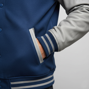 Close-up of a blue and gray varsity jacket with a neutral background