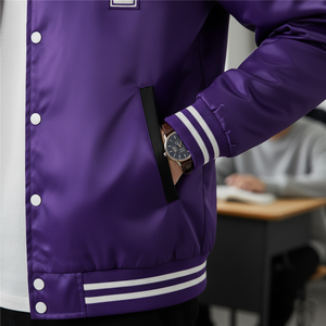 Person wearing a purple varsity jacket with white stripes, holding a phone in a pocket.