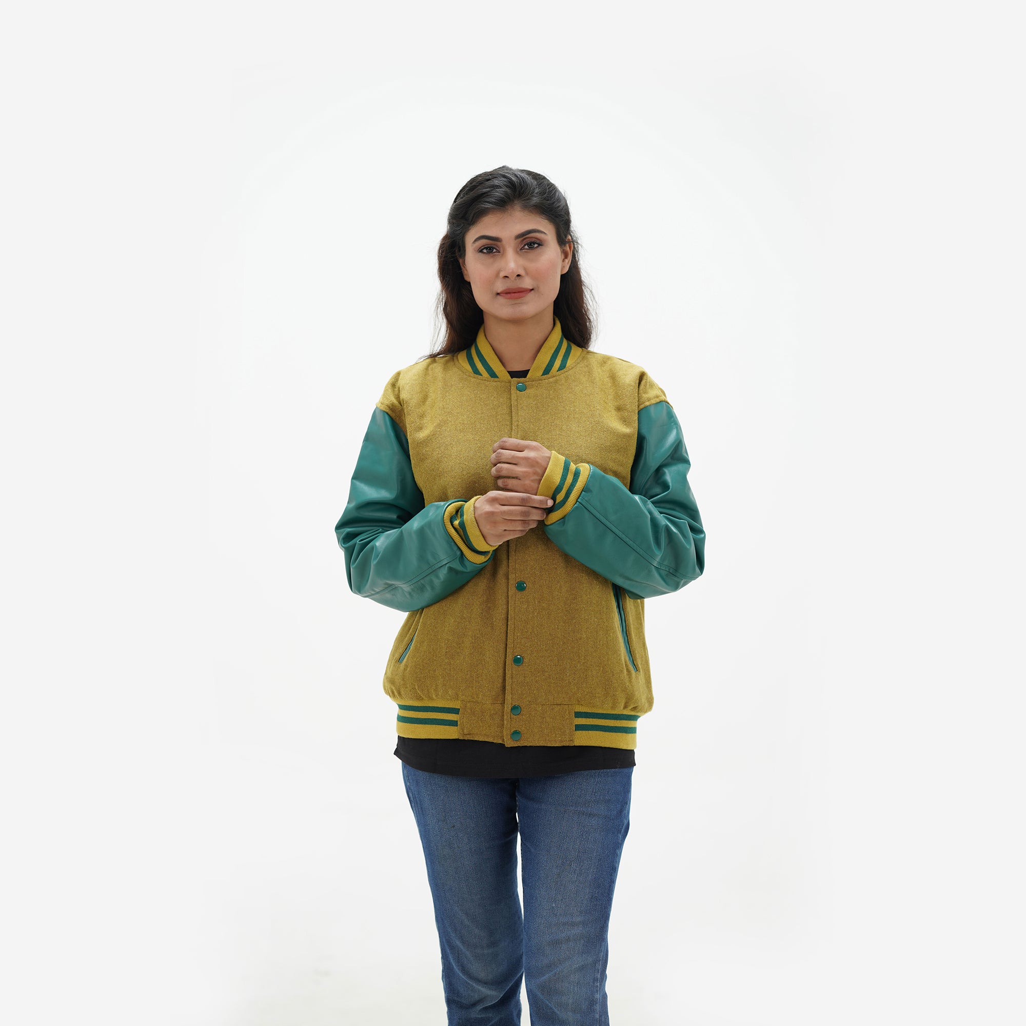 Close-up detail of camel Melton wool body and green genuine leather sleeve junction on women's varsity jacket with ribbed collar trim