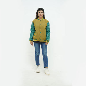 zoomed-out view of women's camel wool varsity jacket with green leather sleeves displaying ribbed hem and premium Melton wool construction