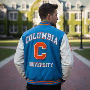 Person wearing a Columbia University letterman jacket on a college campus