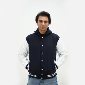Front view of dark blue and white hooded varsity jacket featuring wool body and genuine leather sleeves classic statement