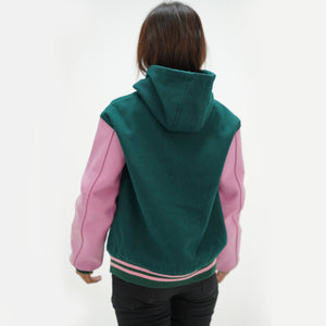 Back view of dark green hooded letterman jacket displaying wool body and white leather sleeves with ribbed waistband