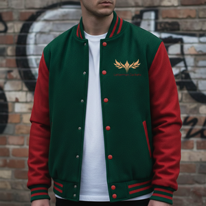 Person wearing a green and red varsity jacket with a logo against a graffiti-covered wall.
