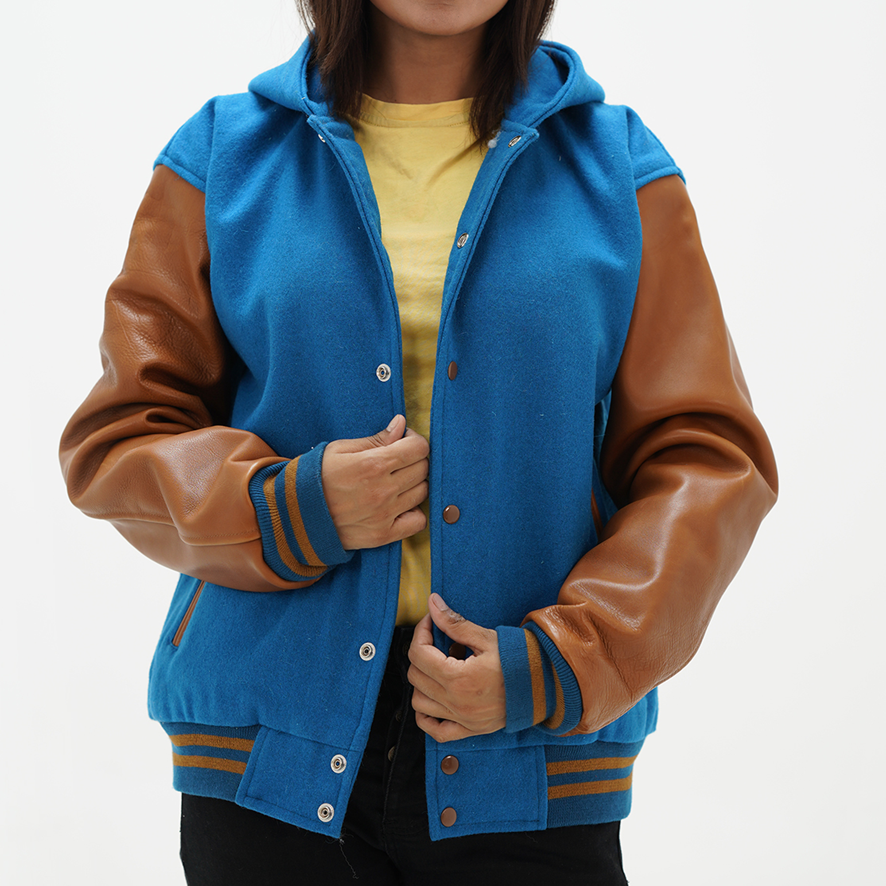 Girls letterman jacket with hood and leather sleeves front view showing snap button closure and adjustable drawstring hood