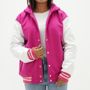 Girls pink and white hooded letterman jacket front view with pink wool body, white leather arms, attached hood, snap button closure, and ribbed collar