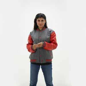 Close-up detail of grey Melton wool and red leather sleeve connection on women's varsity jacket with ribbed trim accents