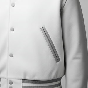 Close-up of a white varsity jacket with a silver emblem on a light gray background