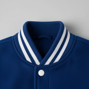 Close-up of a blue jacket with a white striped collar on a gray background