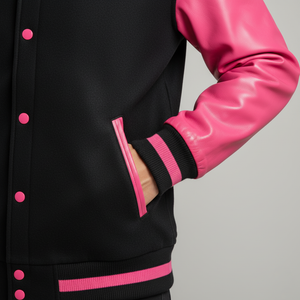 Black and pink varsity jacket with pink sleeves and buttons on gray background