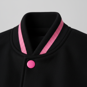 Black jacket with pink trim and button on a gray background