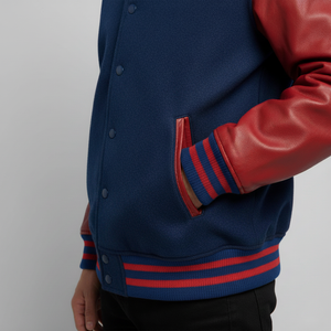 Blue varsity jacket with red accents on a plain background