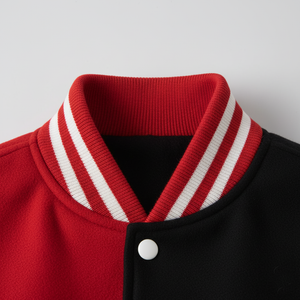 Close-up of a red and black jacket with a white stripe on the collar against a light gray background.