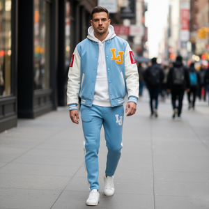 Man wearing a blue and white varsity jacket with 'LJ' logo walking on a city street.