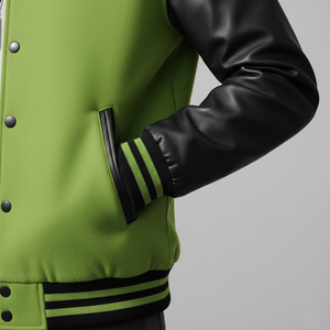Green varsity jacket with black leather sleeves on a gray background