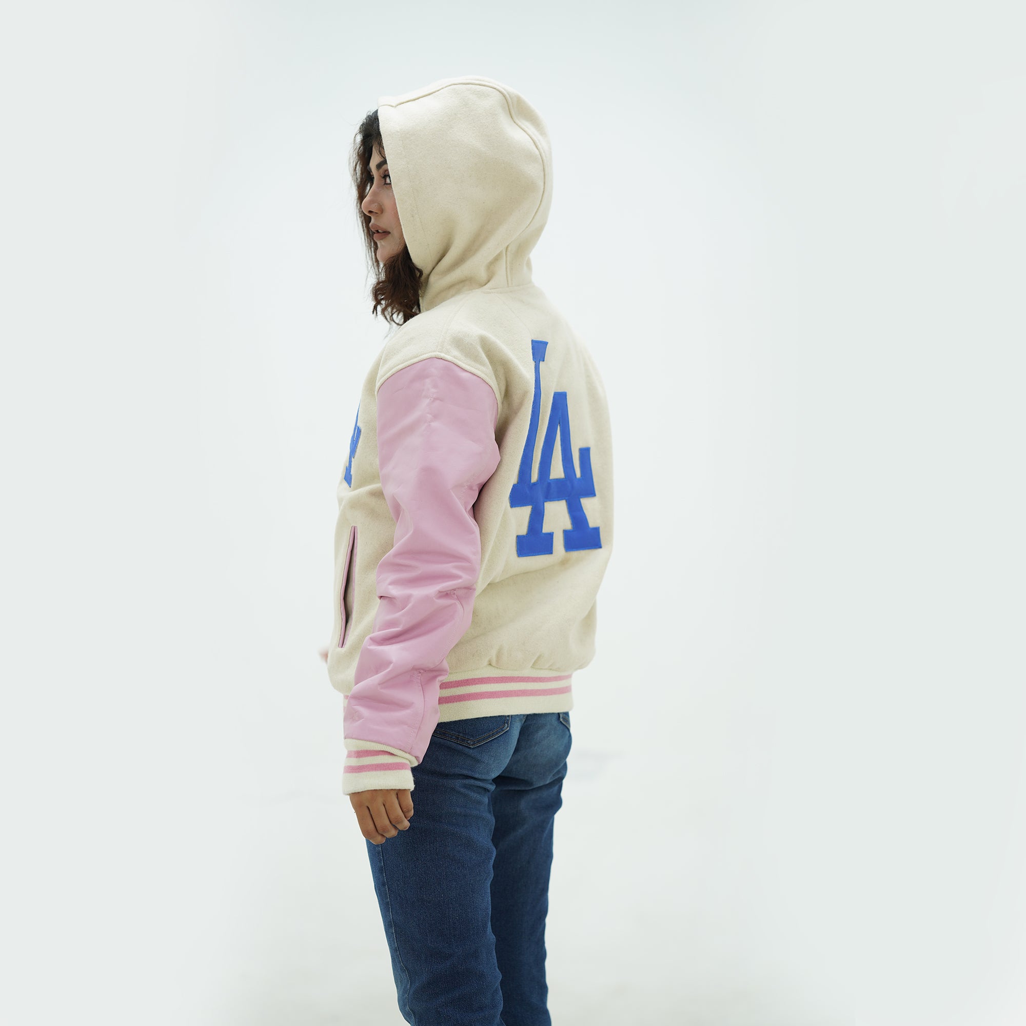 Side angle of Los Angeles Dodgers varsity jacket showcasing white leather arms and wool body construction for baseball supporters