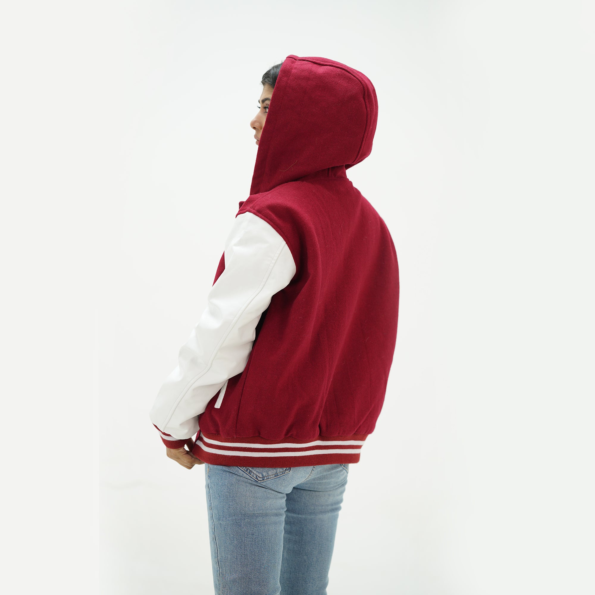 Back view of magenta and white hooded varsity jacket displaying magenta Melton wool body, white genuine leather sleeves, hood, and ribbed waistband