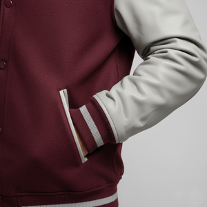 Maroon and gray varsity jacket on a plain background