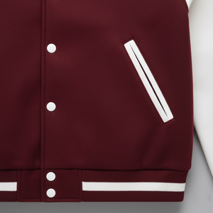 Maroon varsity jacket with white accents on a light gray background