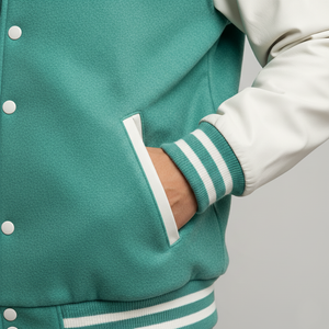 Teal varsity jacket with white accents on a neutral background