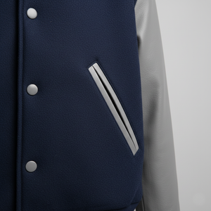Navy blue and gray jacket with button details on a light gray background