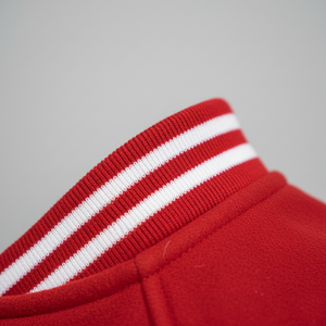 Close-up of a red fabric with white stripes on a gray background