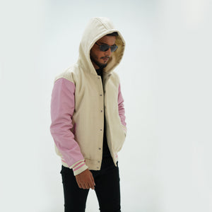Side angle of off white and pink varsity jacket hoodie highlighting genuine cowhide leather arms and premium wool body