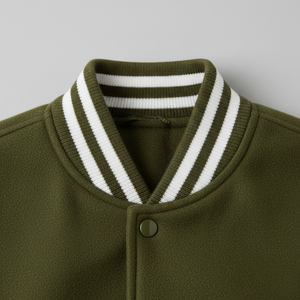 Close-up of a green jacket with a white striped collar on a gray background