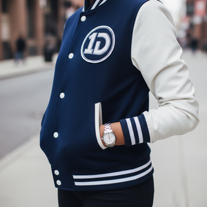 Side angle of One Direction 1D letterman jacket showing white leather sleeve construction, ribbed cuffs, and fan merchandise styling