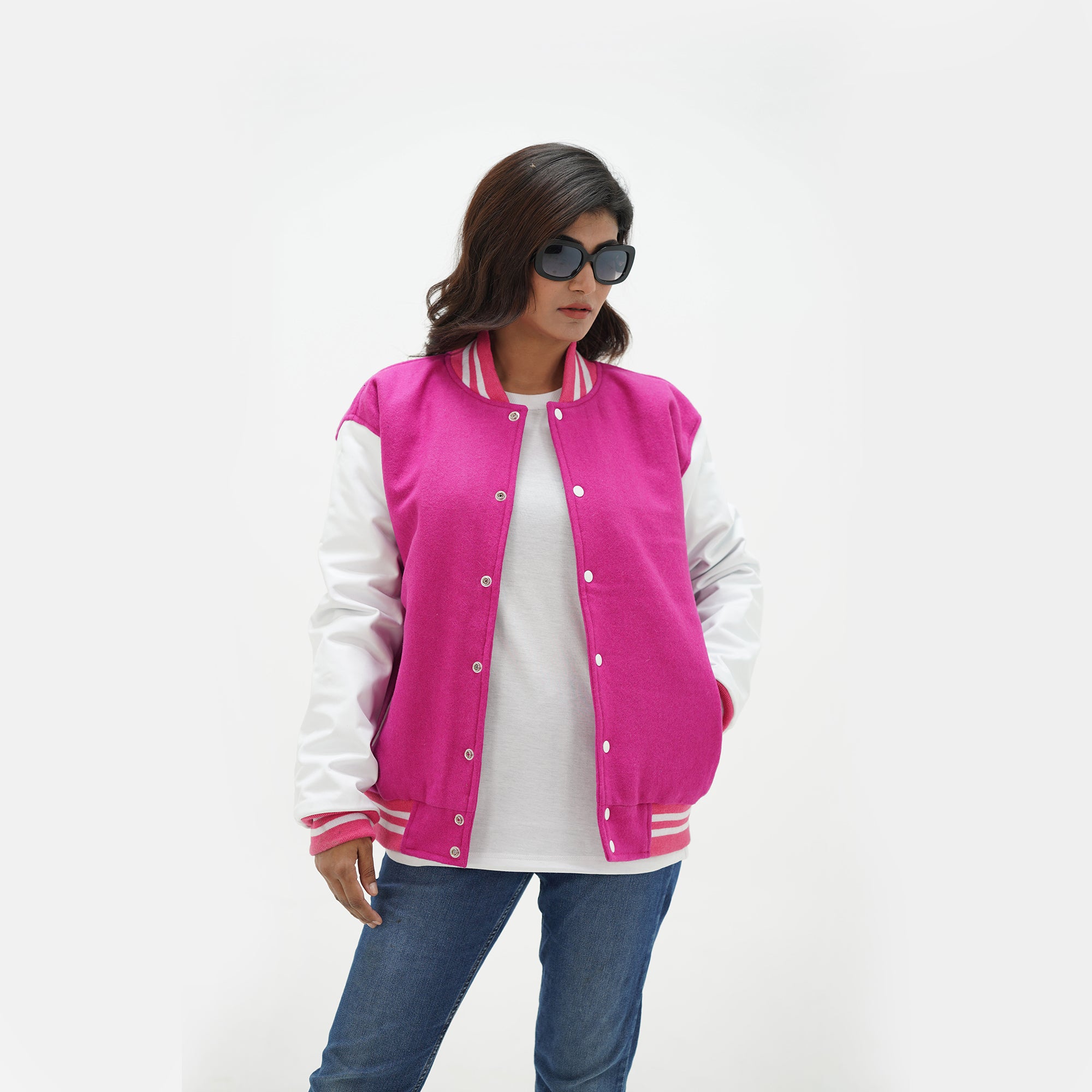 Pink baseball jacket women three-quarter view - showcasing athletic letterman style with leather arms and coordinating pink ribbed trim