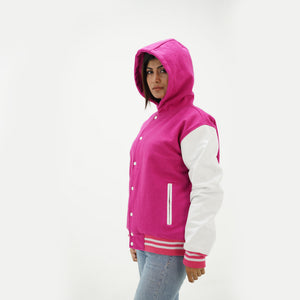 Close-up detail of pink and white hooded varsity jacket featuring pink wool and white leather junction with attached hood and ribbed collar trim