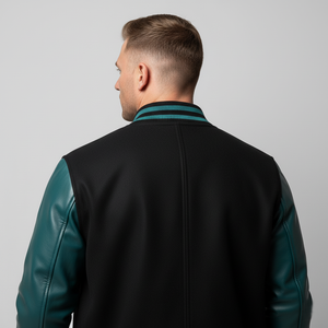 Man wearing a black and teal jacket on a plain background