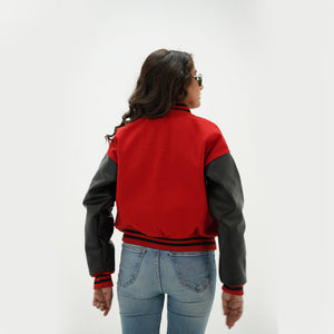 Back view of red and black varsity jacket for women displaying red Melton wool body, black genuine leather sleeves, and ribbed waistband