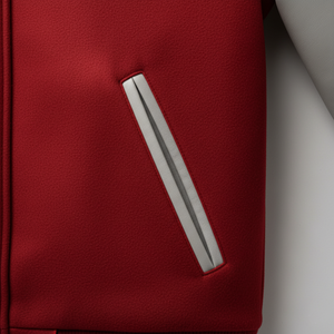 Close-up of a red jacket with a silver zipper on a light gray background
