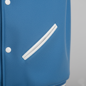 Blue jacket with a white stripe and buttons on a gray background