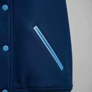 Navy blue varsity jacket with light blue accents on a gray background