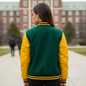 Person wearing a green and yellow varsity jacket on a college campus